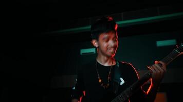 silhouet van een gitarist spelen Aan stadium met humeurig verlichting video
