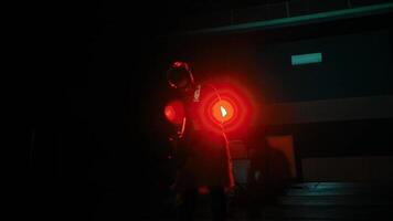 Silhouette of a person holding a guitar in a dark room with neon lights. video