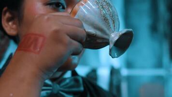 Close-up of a person pouring milk from a jug into a cup, with a focus on the stream of milk. video