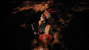 Indigenous person in traditional attire performing a ritual in a forest setting video