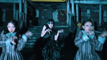 Group of people in period costumes posing dramatically in a dimly lit haunted house setting video