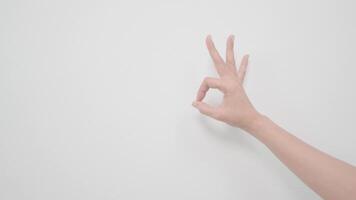 Woman's hand showing OK on white background video