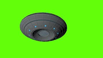 UFO flying round spaceship flying from left to right seen from below against green background. 3D animation video