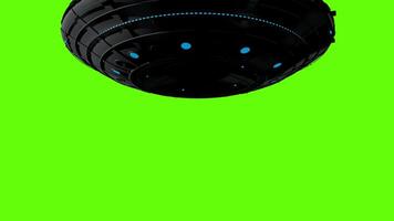 UFO flying round spaceship opening bottom hatch with small fighter ship emerging from inside against green background. 3D animation video