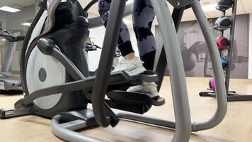 19.10.23 - Mississauga, Canada. GYM. Middle-aged woman goes on an elliptical exercise machine. video