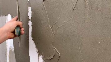 Close-up of a worker's hand with a trowel. Applying mortar to reinforcing mesh and rigid polyurethane foam for home insulation. video