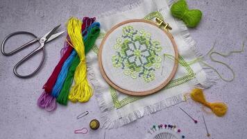 Embroidery with colored threads and various sewing accessories video