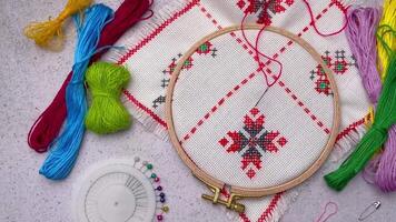 Embroidery with colored threads and various sewing accessories video