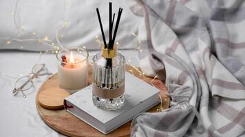 Aroma scented reed diffuser glass is on the tray with scented candle video