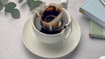 Drip coffee bag with ground coffee in  cup video