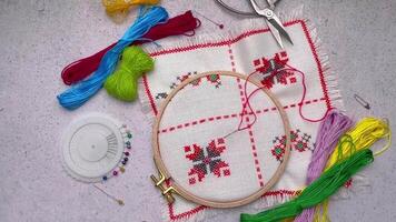 Embroidery with colored threads and various sewing accessories video