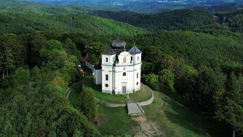 Aerial descending view of Makova hora - Poppy hill a pilgrimage site in Czechia in September 2023 video