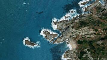 Shapes of cliff and rocks in the ocean from above video