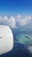 Vertical shot of the view from an airplane over the Maldives. video