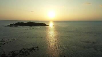 Drone view at a beautiful sunset over the ocean water of the Maldives. video