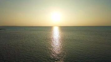 Drone view at a beautiful sunset over the ocean water of the Maldives. video