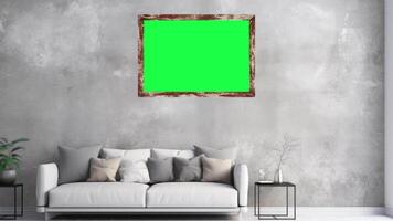 Zoom in Shot of a wall frame with Horizontal Green Screen Mock Up. Living Room with a Sofa and plant. video