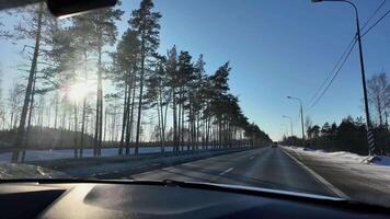 The view from the car window is forward. A car driving on the highway in winter video