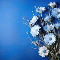 ai generado ramo de flores de campo acianos en un azul antecedentes con espacio para texto. foto