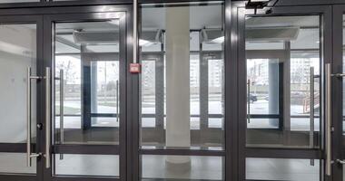 loop rotation and panoramic view in empty modern entrance hall with doors overlooking the city. video