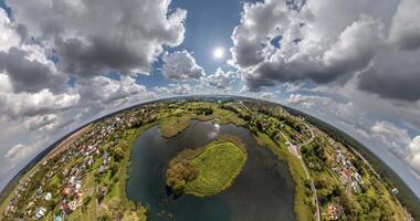 green little planet transformation with curvature of space among fields with river in sunny day and beautiful clouds video