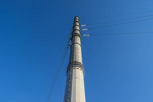 Supports high-voltage power lines against the blue sky photo