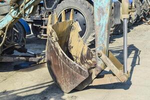 Tractor with a bucket for digging soil photo