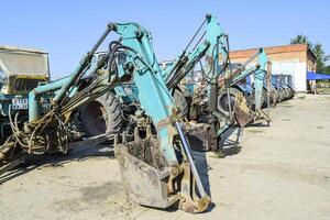 Tractor with a bucket for digging soil. Bulldozer and grader. photo