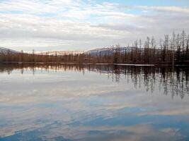 River landscape Early spring. bare trees, melting snow. photo