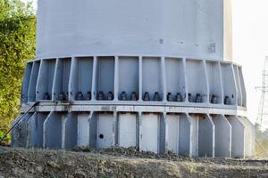 The base of the column power line support. Massive metal pole photo