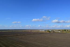 plowed field in the spring in the village. Agricultural land in the Kuban. Preparation of fields for sowing wheat. photo