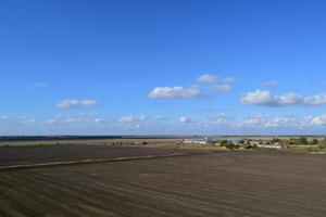 plowed field in the spring in the village. Agricultural land in the Kuban. Preparation of fields for sowing wheat. photo