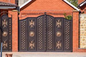 Gates of brown metal sheets. Roofing materials. photo