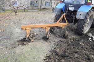 Tractor plowing the garden. Plowing the soil in the garden photo