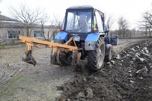 Tractor plowing the garden. Plowing the soil in the garden photo