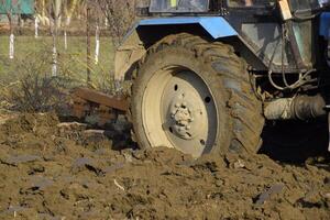 Tractor plowing the garden. Plowing the soil in the garden photo