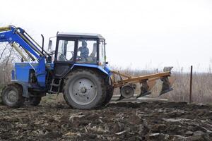 Tractor plowing the garden. Plowing the soil in the garden photo