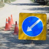 Sign of detour travel. Pit on the road. repair work. photo