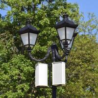 The loudspeaker on the pole. Outdoor speakers for fun walking in the park. A pillar with lights and speakers. photo