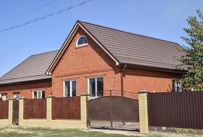 Detached house with a roof made of steel sheets. photo