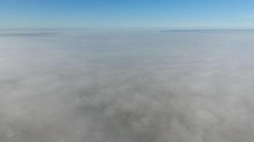 Fog above the ground. Top view of the fog. Low clouds. Morning mist condensation. Shooting with a drone photo