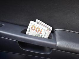 Several notes of US dollars and are folded in half in the door h photo