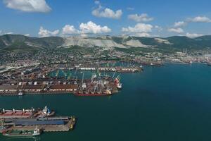 Industrial seaport, top view. Port cranes and cargo ships and barges. photo