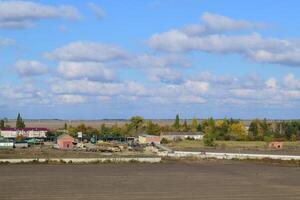 A view from above of a small Russian village. Rural landscape. Field and village. A semi-abandoned village. photo