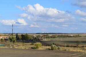 A view from above of a small Russian village. Rural landscape. Field and village. A semi-abandoned village. photo