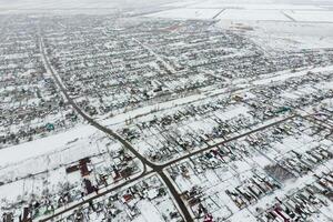Winter view from the bird's eye view of the village. The streets are covered with snow photo