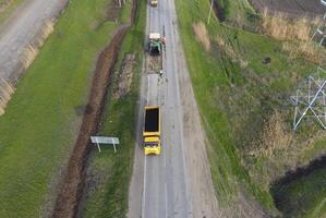 Top view of the road repair. Technics for repair of asphalt. Replacement of asphalt pavement. photo