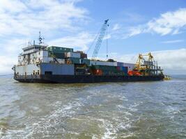 The cargo ship with the crane, the top view. Pipelaying barge. photo