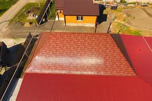 A house with a canopy over the courtyard. Roof from corrugated metal profile. Metal tiles. photo
