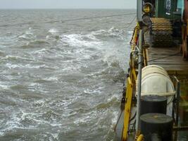 Ship in the sea. The edge of the barge deck photo